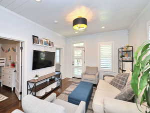 Living area with crown molding, shiplap ceiling, dark hardwood floors, and recessed lighting