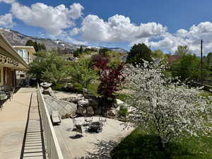 Balcony featuring an outdoor living space with a fire pit, a mountain view, and a patio