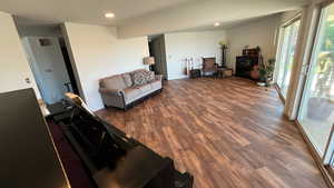 Living room featuring recessed lighting, wood finished floors, and visible vents