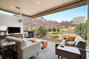 Exterior space featuring expansive windows and wood ceiling