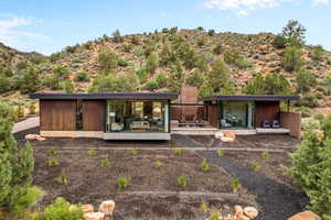 Back of property with a mountain view and a chimney