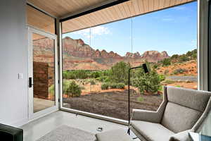 Doorway to outside featuring a mountain view, finished concrete floors, plenty of natural light, and baseboards