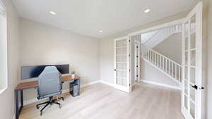 Office area with baseboards, recessed lighting, wood finished floors, and french doors