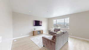 Living area featuring light wood-type flooring, recessed lighting, and baseboards