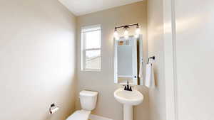 Bathroom featuring baseboards and toilet