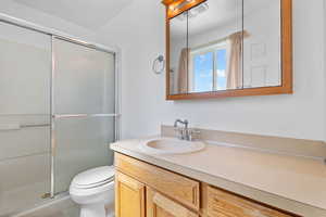 .75 bath with toilet, a shower stall, and vanity