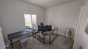 Carpeted home office or bedroom with baseboards