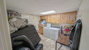 Basement laundry area with cabinet space and independent washer and dryer
