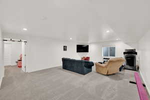 Single story home with a garage, a front lawn, fence, and driveway