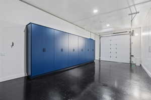 Garage featuring baseboards