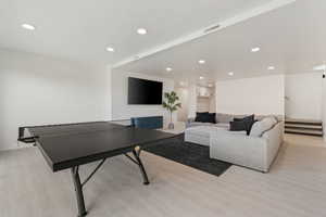Rec room featuring visible vents, recessed lighting, and light wood-style flooring