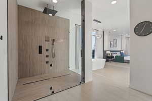 Full bathroom featuring a freestanding bath, recessed lighting, wood finished floors, ensuite bath, and tiled shower