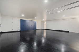Garage featuring baseboards and recessed lighting