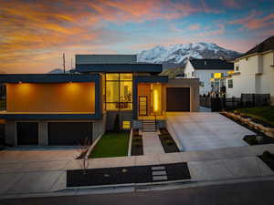 Modern home featuring driveway, a mountain view, and stucco siding