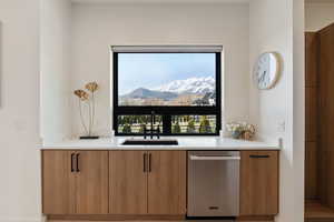 Bar with a sink, a mountain view, and dishwasher