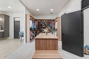 Walk in closet featuring visible vents and light wood-style flooring