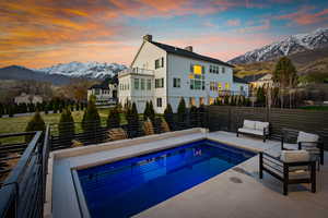 View of swimming pool featuring a mountain view, a fenced in pool, and fence