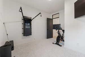 Exercise area with carpet and baseboards