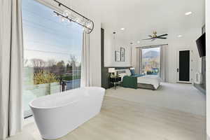 Bedroom with wood finished floors, recessed lighting, and a ceiling fan