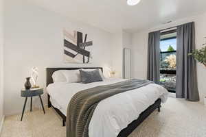 Carpeted bedroom with visible vents and baseboards