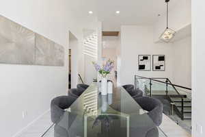 Dining space featuring stairway, a chandelier, recessed lighting, and baseboards