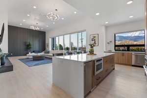 Kitchen with recessed lighting, modern cabinets, an inviting chandelier, and appliances with stainless steel finishes