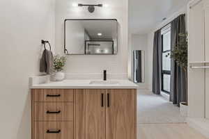 Bathroom featuring visible vents, wood finished floors, and vanity