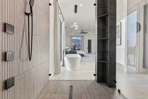 Hall featuring an inviting chandelier
