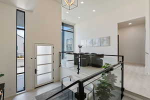 Entrance foyer featuring recessed lighting, a notable chandelier, wood finished floors, and a healthy amount of sunlight