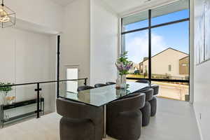 Dining space with wood finished floors, expansive windows, and baseboards