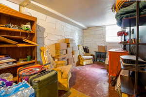 Basement with a textured ceiling and a wood stove