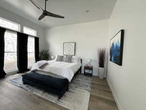 Bedroom featuring baseboards, a ceiling fan, and wood finished floors