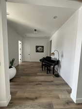 Corridor featuring recessed lighting, baseboards, and wood finished floors