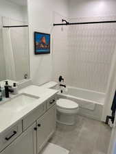 Bathroom with toilet, vanity, and shower / tub combo with curtain