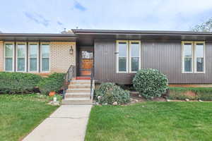 Front of Home with Floor to Ceiling Windows