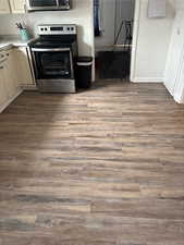 Kitchen with wood finished floors and stainless steel electric range