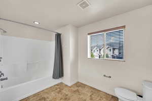 Full bathroom featuring recessed lighting, shower / bath combo with shower curtain, toilet, baseboards, and visible vents
