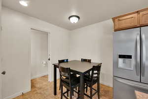 Dining space with light tile patterned floors and baseboards