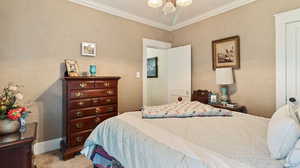Bedroom with carpet flooring, crown molding, and a notable chandelier