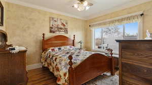 Bedroom with a ceiling fan, baseboards, ornamental molding, and wood finished floors