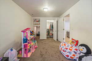 Basement bedroom 2 with nice walkin closet and under stair storage/play area.