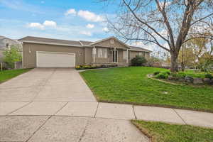 Ranch-style house with concrete driveway, a front yard, and an attached garage
