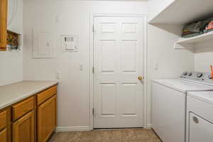 Laundry area with cabinet space for storage and folding station.