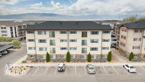 View of property featuring uncovered parking and a mountain view