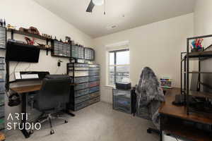 Office space with ceiling fan, carpet floors, and visible vents