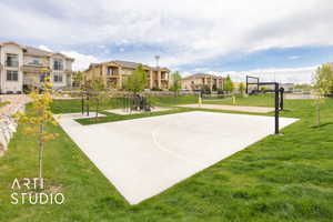 View of basketball court with volleyball court, a residential view, and a lawn