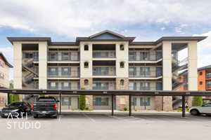 View of building exterior with covered parking