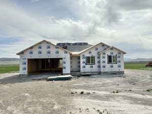 Unfinished property featuring a garage