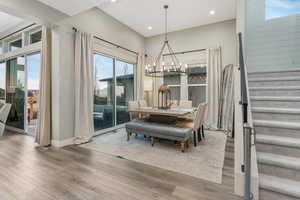 A stunning chandelier illuminates this elegant dining room, perfectly complementing its picturesque views.