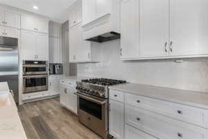 Elegant custom cabinetry and top-tier appliances elevate this space with a luxurious feel, blending style and functionality seamlessly.